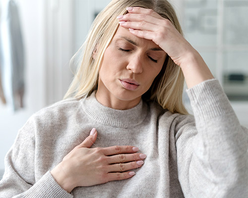 WEAK IMMUNITY Woman feeling unwell holding head
